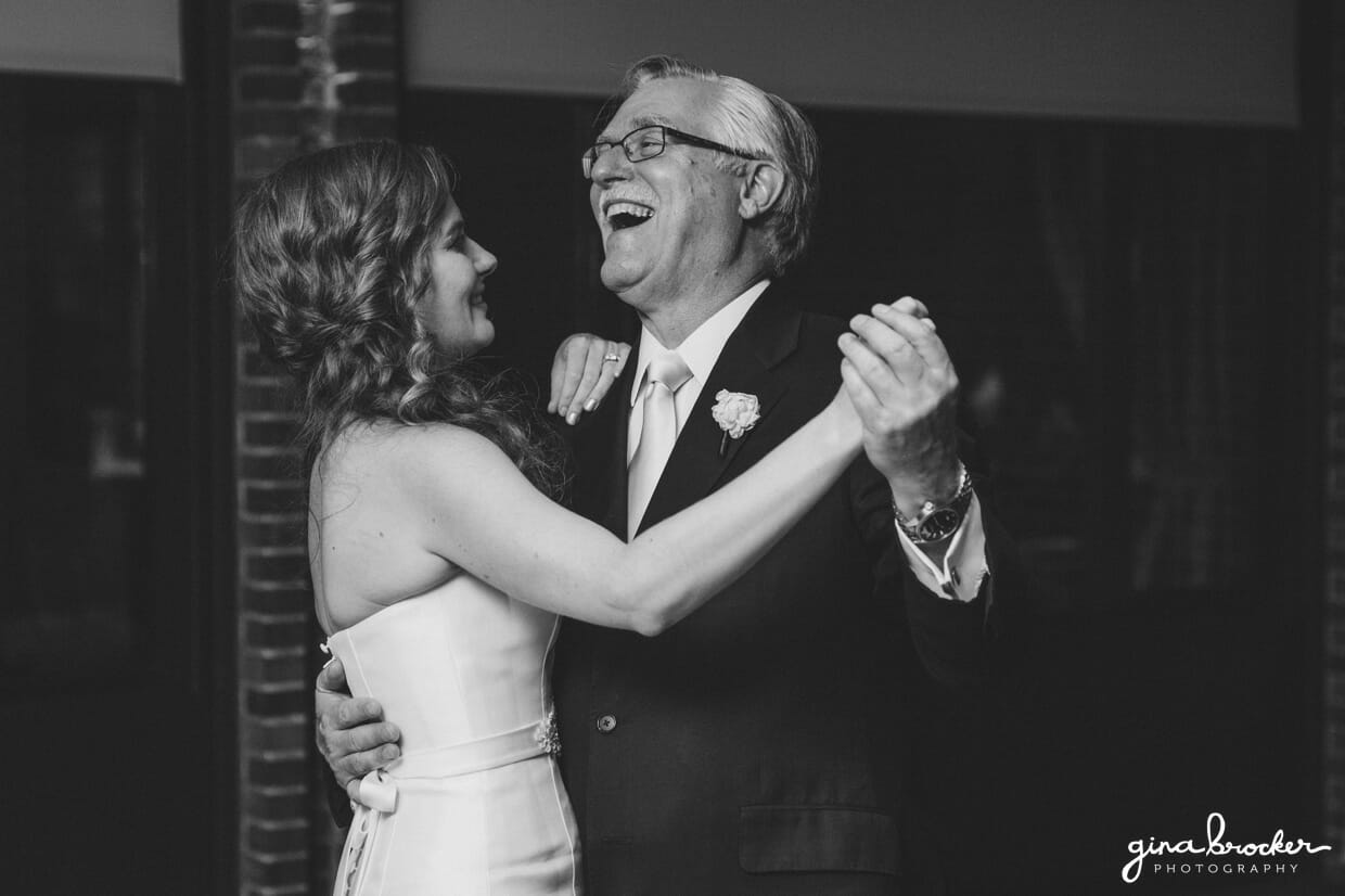 The father of the bride laughs during the father daughter dance at an elegant and classic Boston wedding