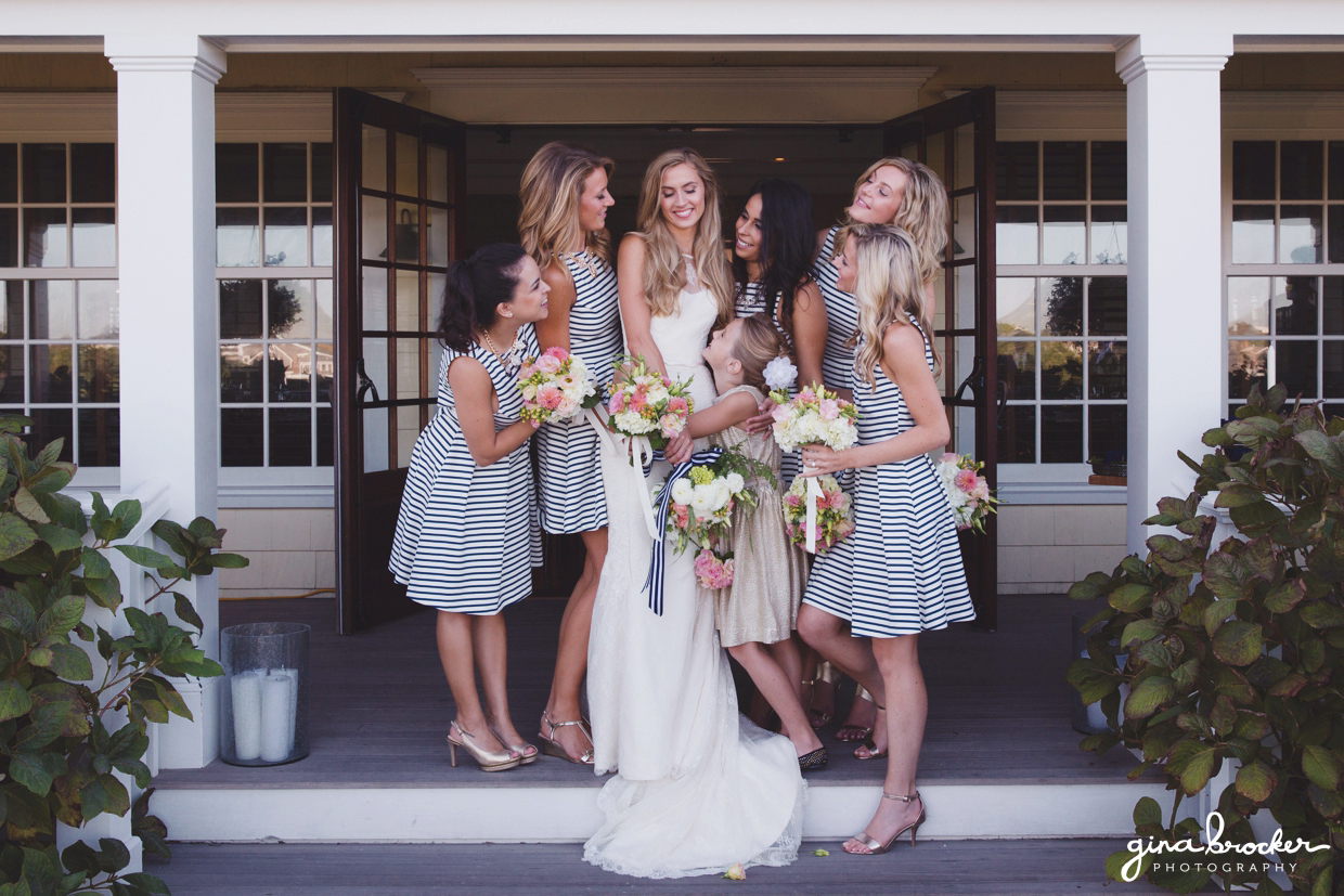 A casual and sweet group photograph of a bride with her bridesmaids wearing nautical inspired dresses