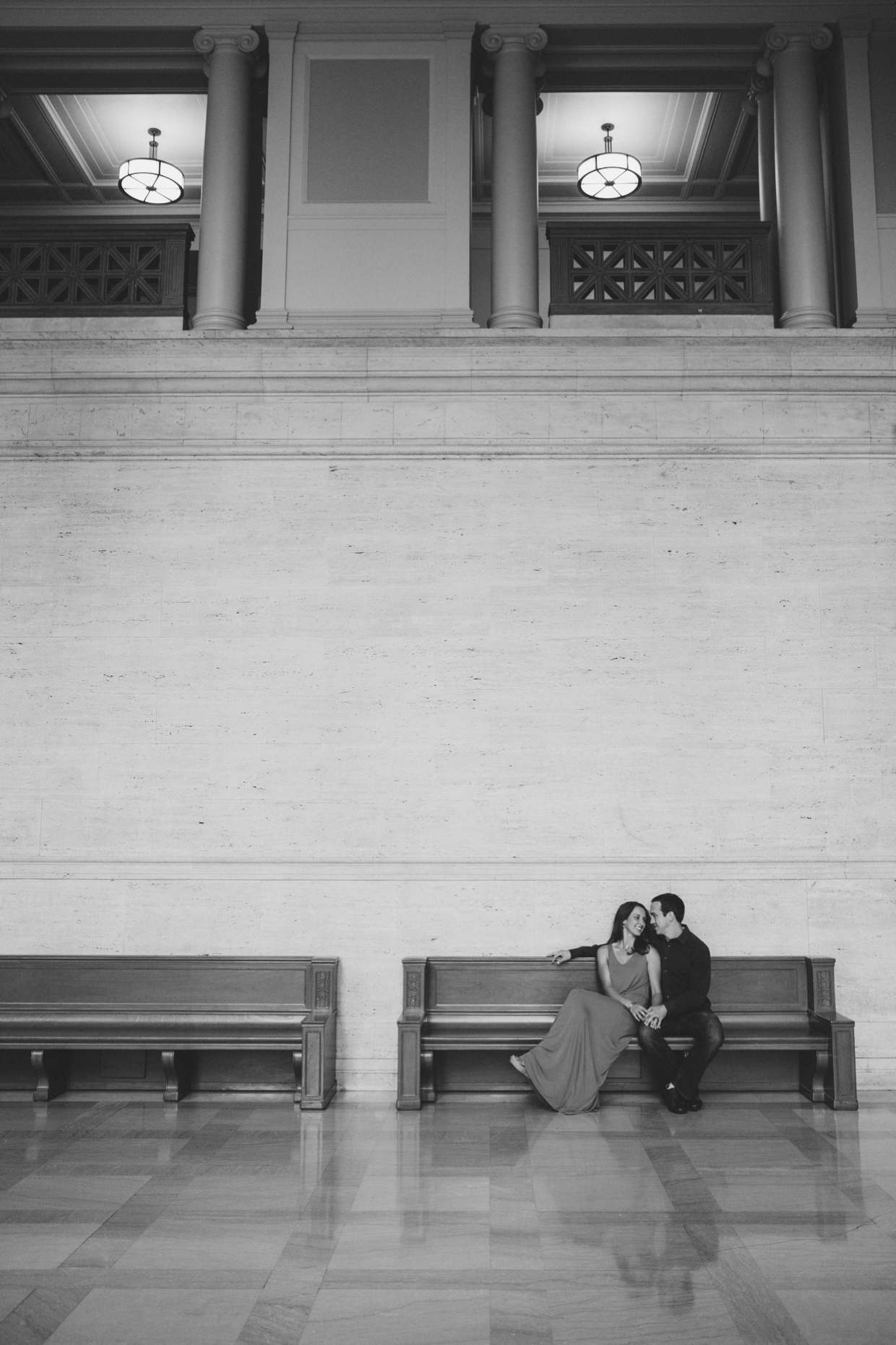 A natural photograph of a couple cuddling on a bench during their couple session at the Massachusetts Institute of Technology.