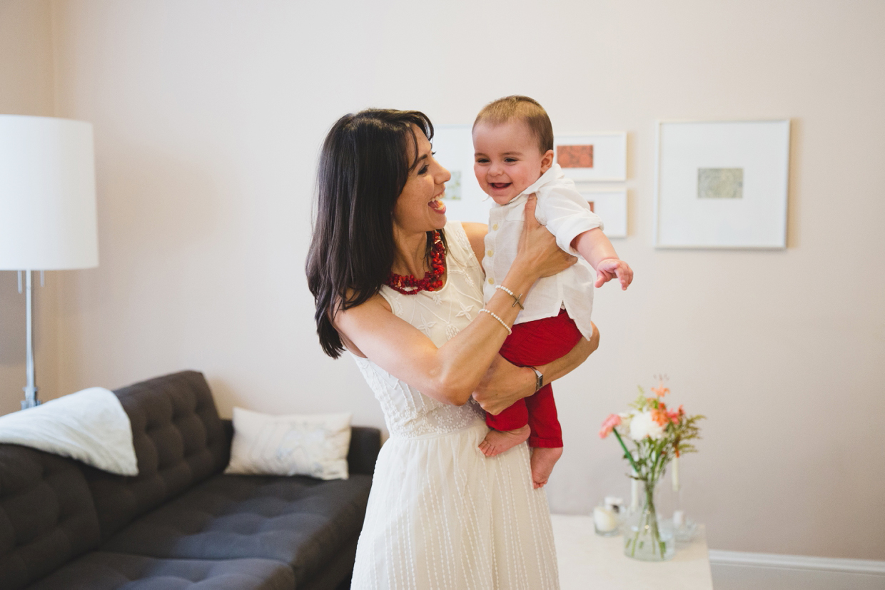 A natural and fun portrait of a mother holding her baby boy in their Boston home. 