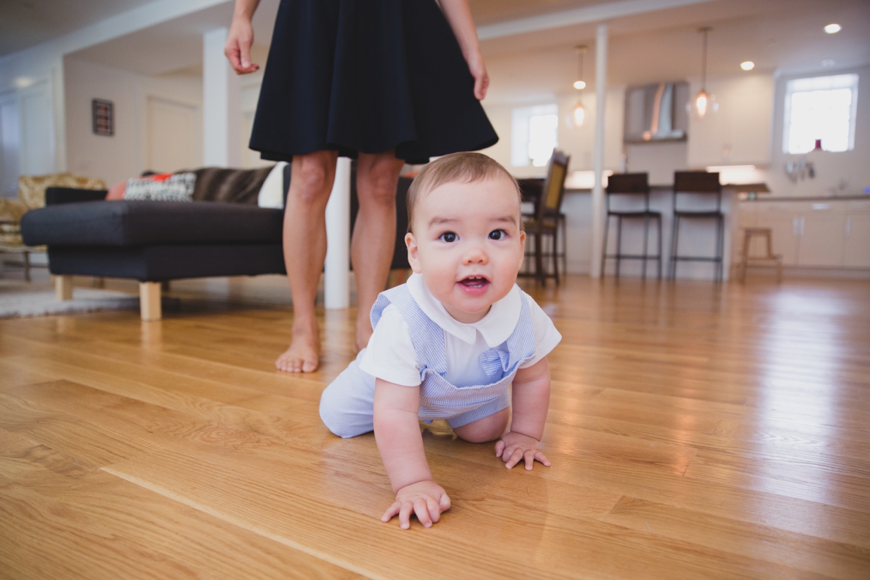 A cute photograph of a baby boy crawling during an in home family photo session in Jamaica Plain