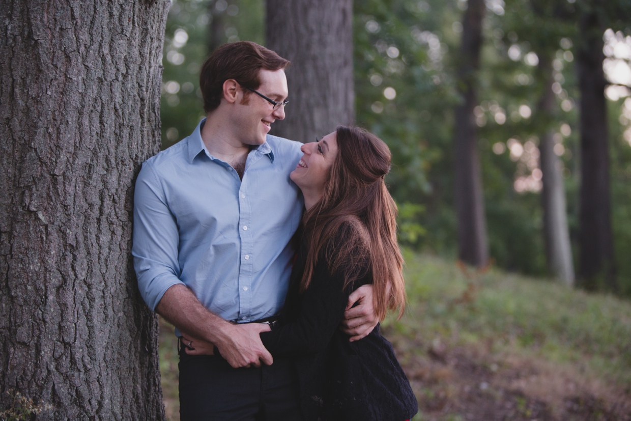 A sweet portrait of a couple leaning against a tree in the Arnold Arboretum in Boston, Massachusetts