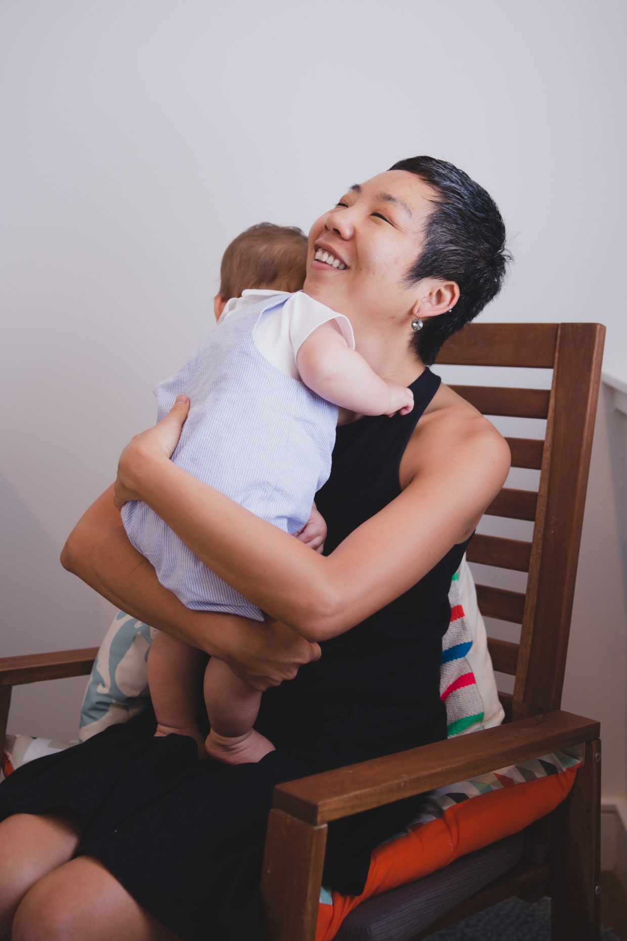 A sweet photograph of a mother holding her baby boy during their in home family photo session in Jamaica Plain