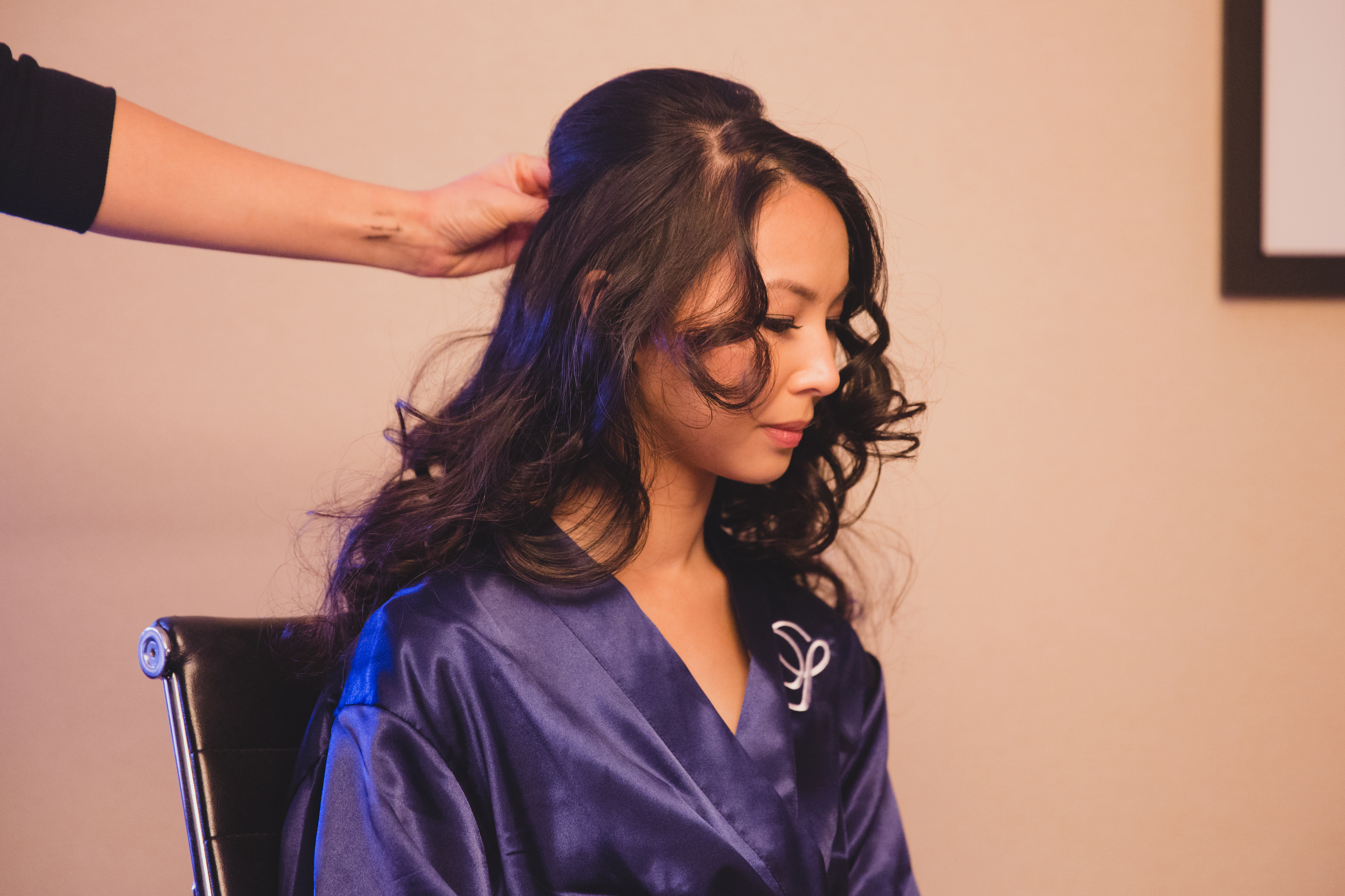 A bride gets her hair done before her vietnamese tea ceremony in Boston
