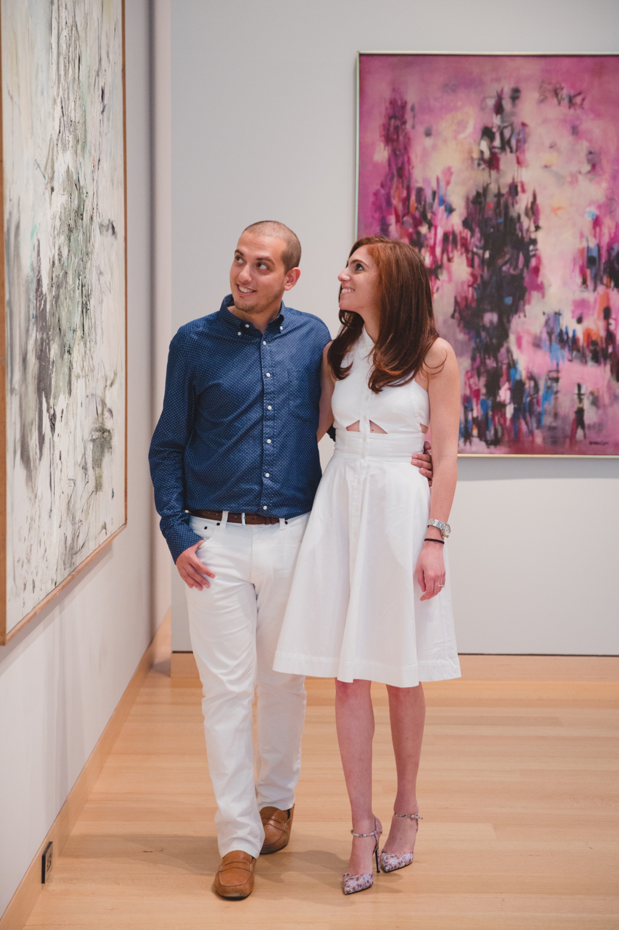 A sweet and relaxed photograph of a couple looking at art work during their engagement session at the Boston Museum of Fine Arts