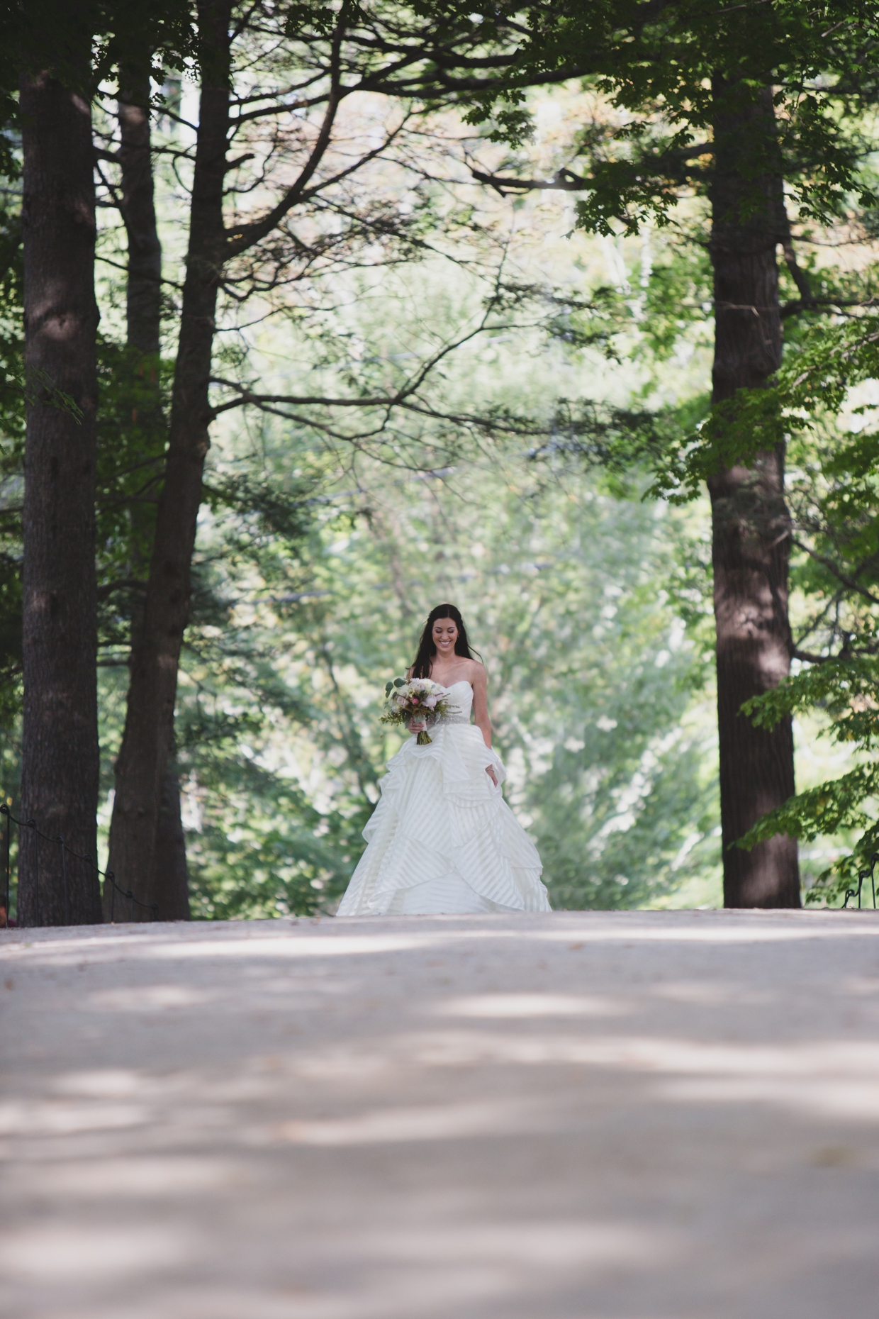 A beautiful candid portrait of a bride walking to meet her groom during the first look of their backyard wedding