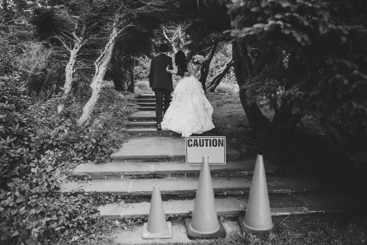 A cool and funny photograph of a couple walking behind a caution sign at the Minute Man Park in Massachusetts