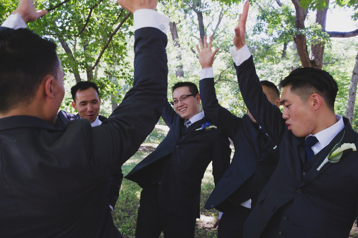 A fun photograph of groomsmen hanging out at the Arnold Arboretum before a wedding at the Boston Marriott Hotel
