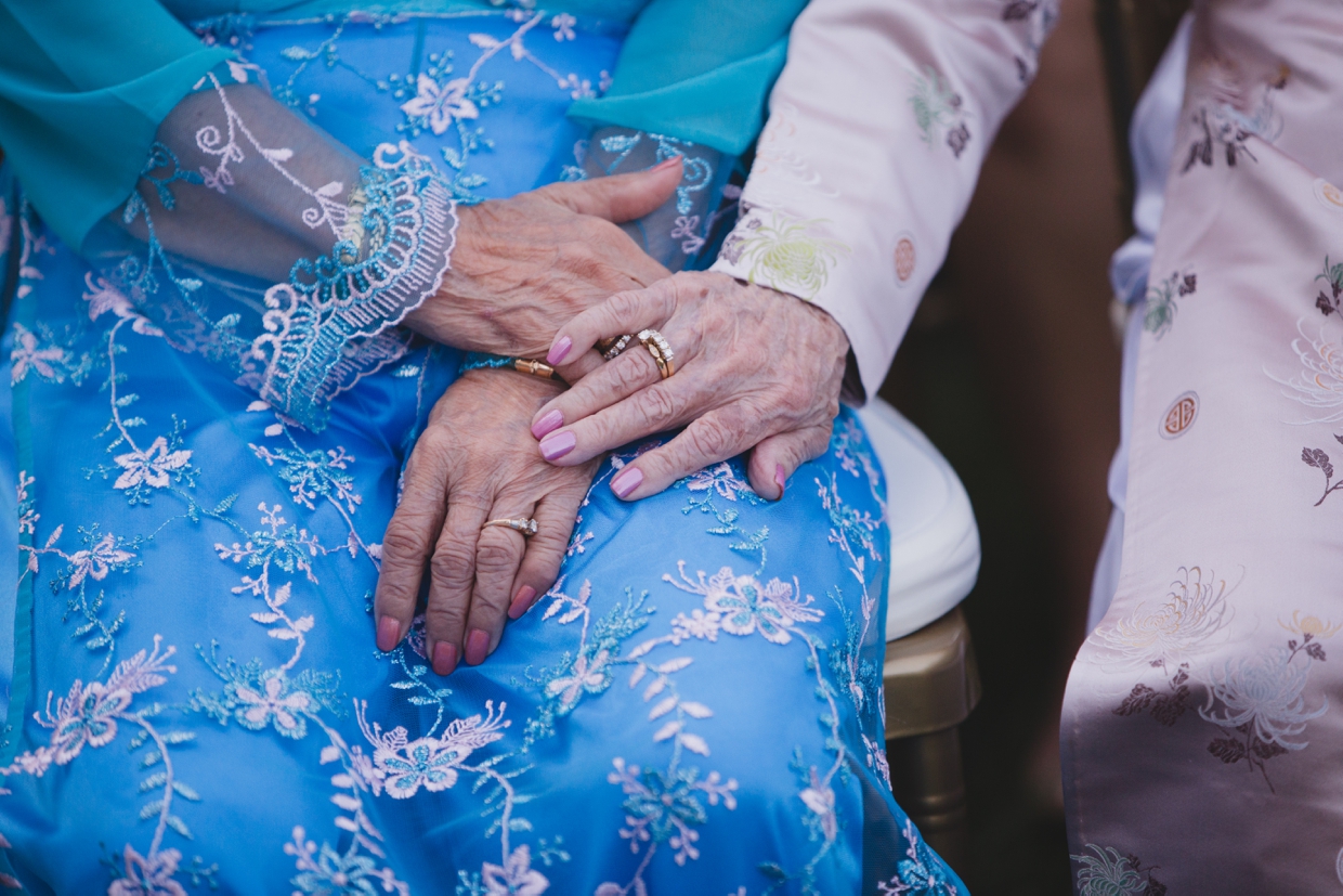 A detailed photograph of two grandmother's hands during a wedding ceremony at the Boston Marriott Hotel