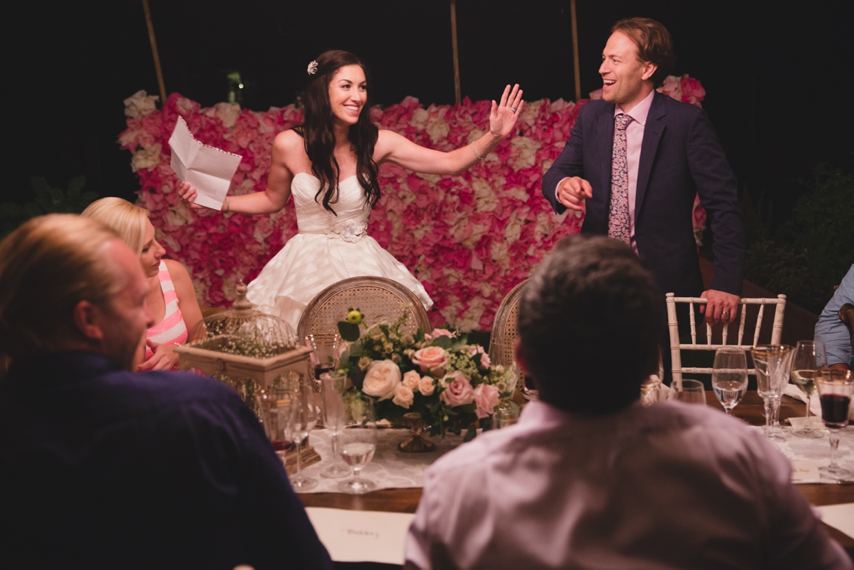 A fun and candid photograph of a bride and groom playing party games at their backyard wedding in Massachusetts