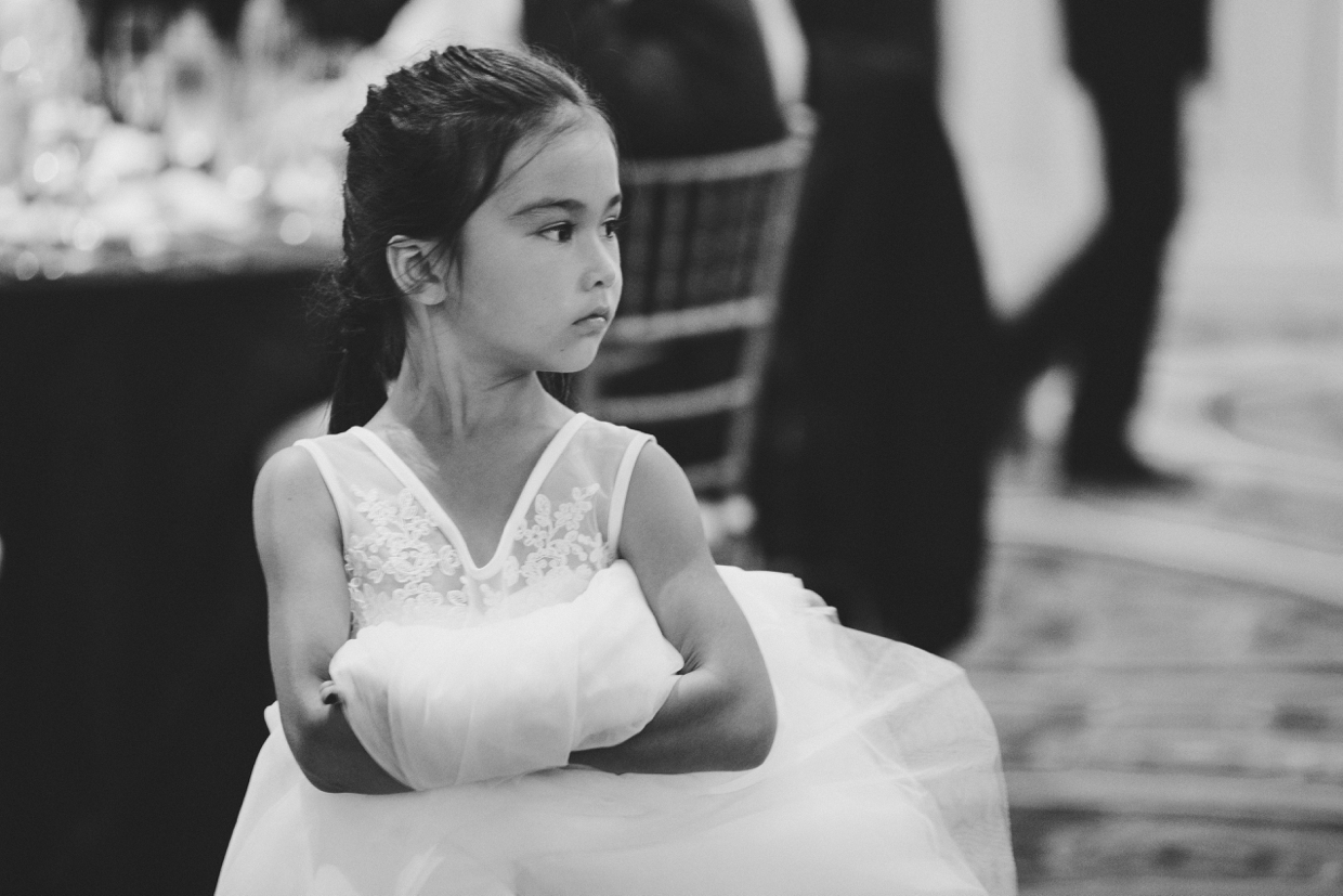A beautiful photograph of a flower girl watching the speeches during a wedding at the Boston Marriott Hotel