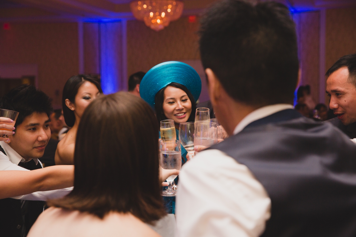 A bride shares a toast with guest during her Vietnamese wedding at the Boston Marriott Hotel