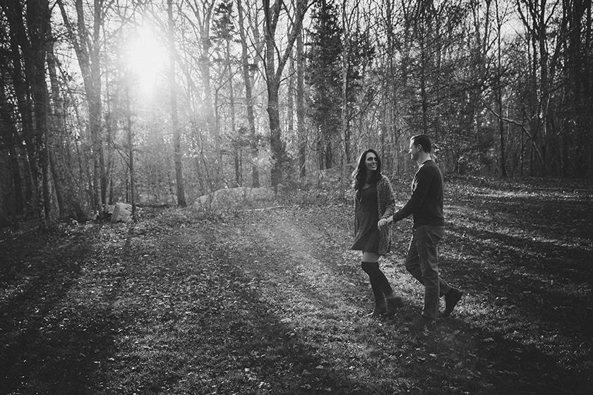 Couple walking through the woods during their fall engagement session at Borderland State Park