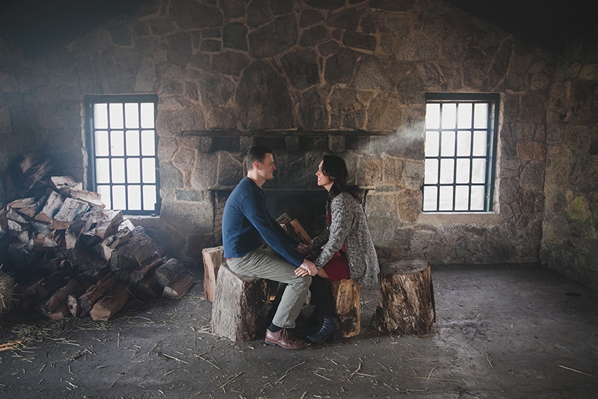 A unique portrait of a couple sitting in a stone cabin during their Borderland State Park Engagement Session