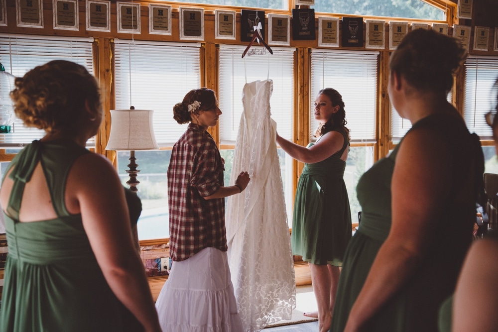 A documentary photograph of a bride and bridesmaids getting ready at a family home before a rustic River Club Wedding in Scituate, Massachusetts