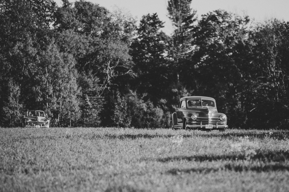 A documentary photograph of two brides being driven to their wedding ceremony at Kitz Farm in New Hampshire