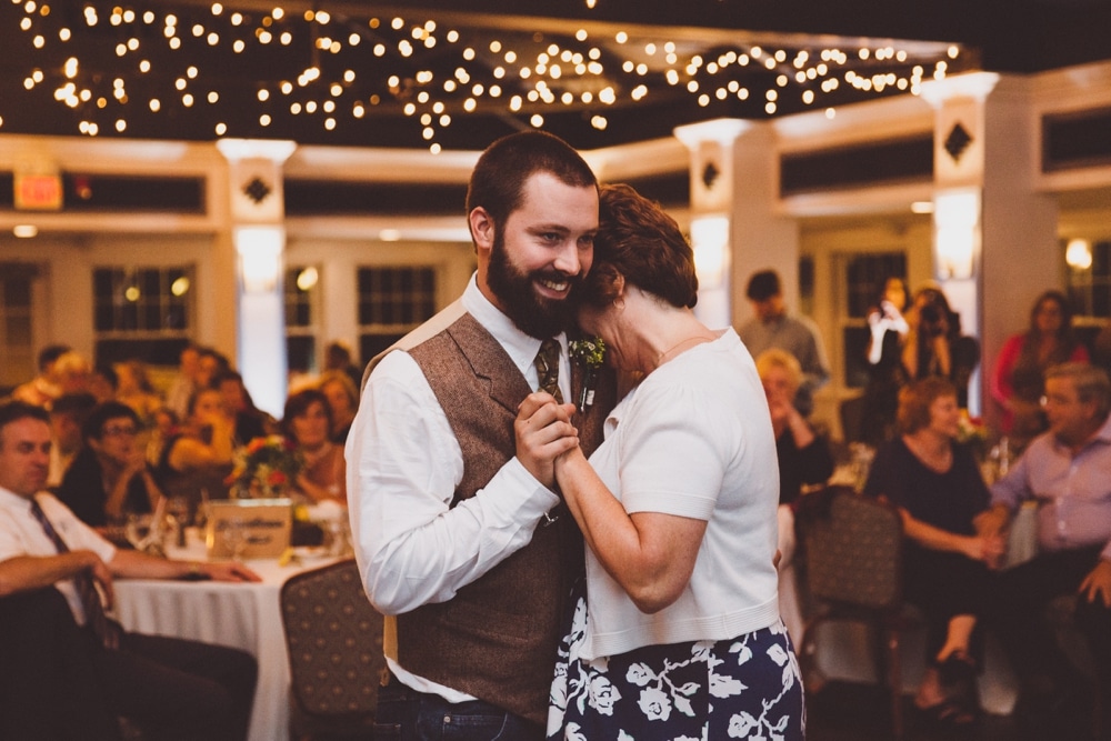 A photojournalistic photograph of a groom dancing with his mother during a relaxed and rustic River Club Wedding in Scituate, Massachusetts