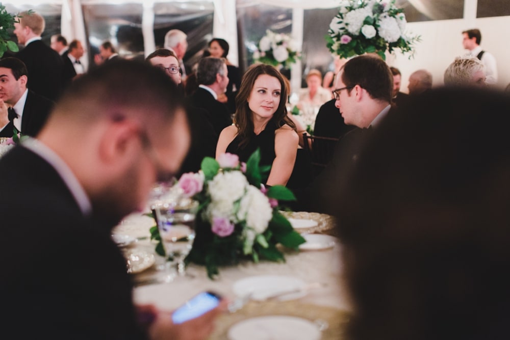 A documentary photograph of guest talking during a wedding reception at the Castle Hill Inn in Newport, Rhode Island
