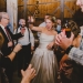 A bride celebrates with friends during her rustic barn wedding at Kitz Farm in New Hampshire