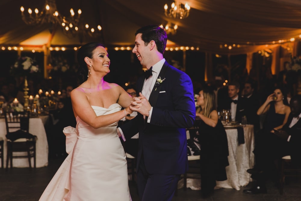 A bride and groom smile during their first dance at their Castle Hill Inn Wedding in Newport, Rhode Island