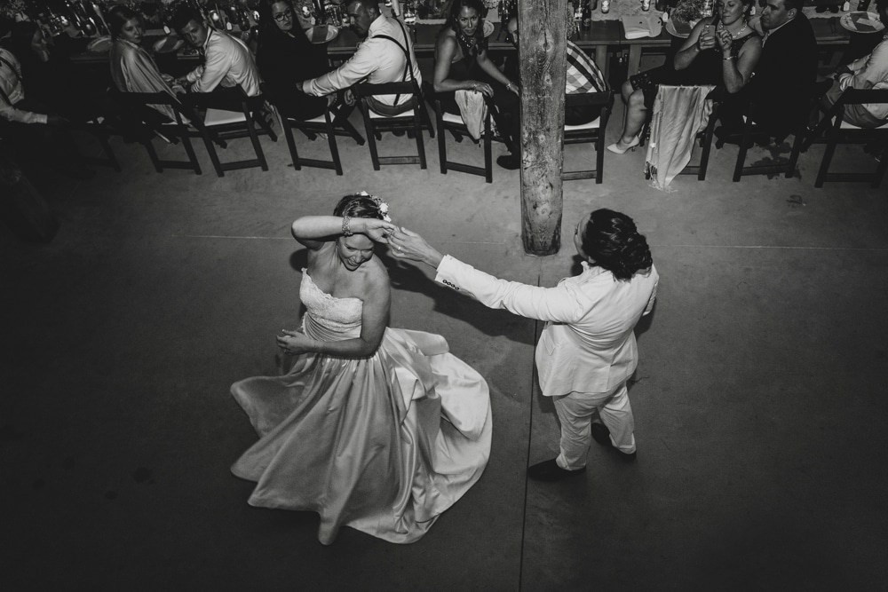 A documentary photograph of a bride and bride having their first dance during their rustic barn wedding at Kitz Farm in New Hampshire
