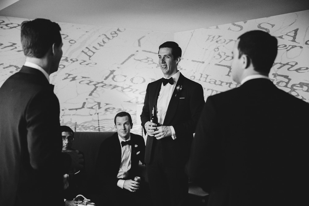 A photojournalistic photograph of a groom getting ready with his groomsmen at the Hyatt Regency Hotel before his wedding at the Castle Hill Inn in Newport, Rhode Island