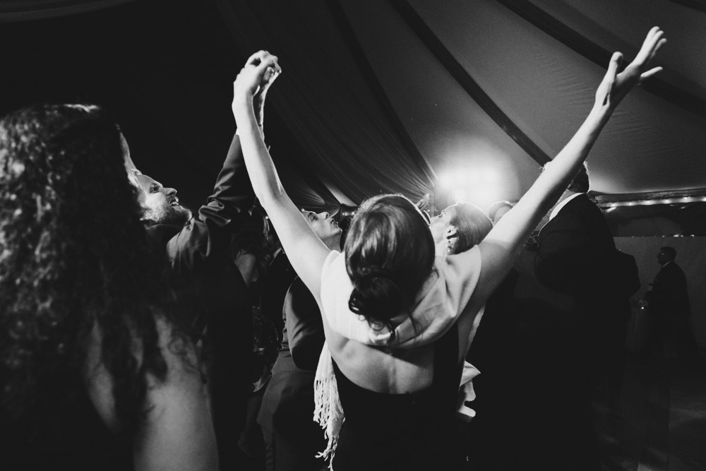 A documentary photograph of a guests dancing during a wedding at the Castle Hill Inn in Newport, Rhode Island