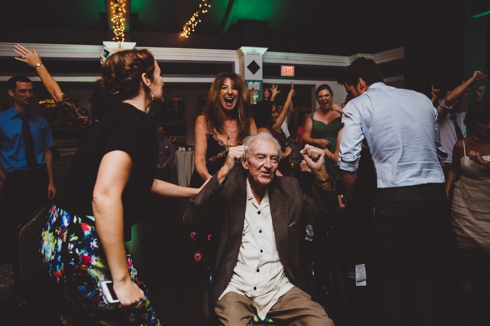 A fun documentary photograph of wedding guests dancing during a laid back wedding at the River Club in Massachusetts