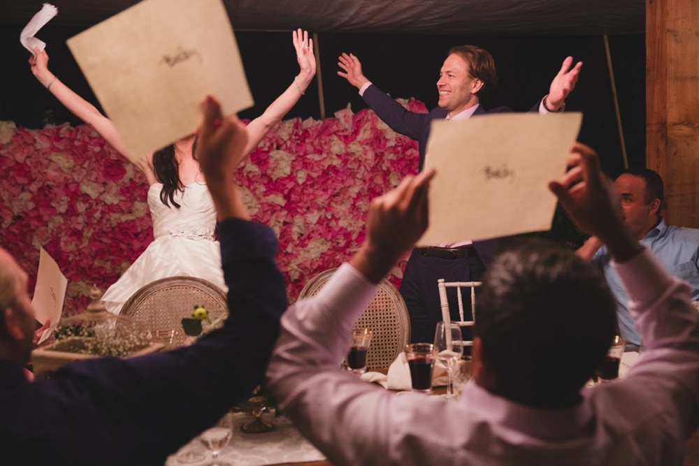 A documentary photograph of wedding guests playing a game during a backyard wedding in Massachusetts