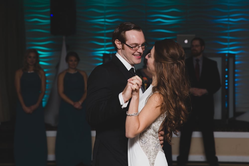 A photojournalistic photograph of a bride and groom sharing their first dance as husband and wife during an intimate Massachusetts Wedding the Oceanview of Nahant