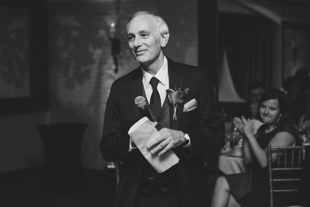 A documentary photograph of the father of the groom giving a toast to the bride and groom during their intimate Massachusetts wedding at the Oceanview of Nahant