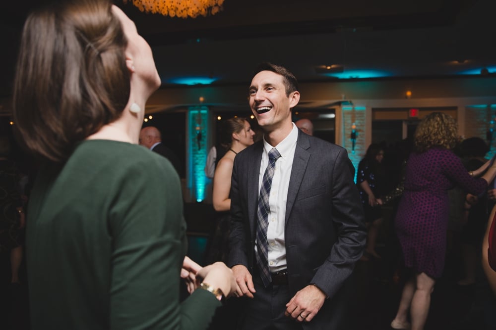A photojournalistic photograph of a couple dancing during an intimate and fun Massachusetts wedding at the Oceanview of Nahant