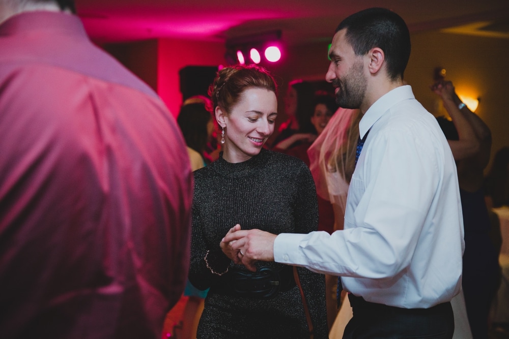 A photojournalistic photograph of guests dancing during a summer Cape Cod Wedding