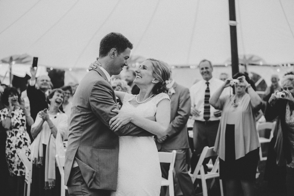 A fun photojournalistic photograph of a bride and groom sharing their first dance during a summertime, Cape Cod wedding at Pilgrim's Monument in Provincetown, Massachusetts