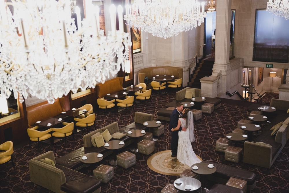 A bride and groom kiss during their first look at the Bond Lounge in Langham Hotel before their State Room Wedding in Boston