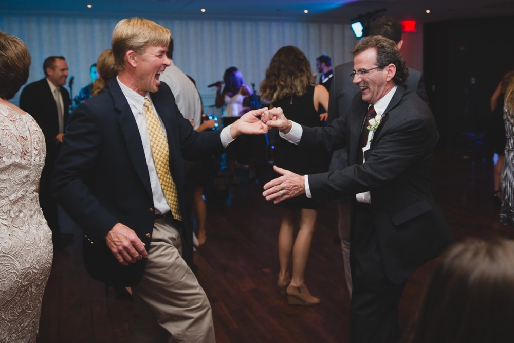 A photojournalistic photograph of men dancing at a State Room Wedding in Boston