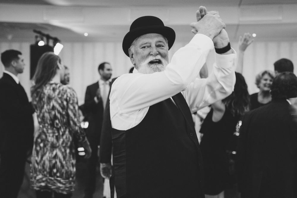 A documentary photograph of a father of the groom dancing at a State Room Wedding in Boston