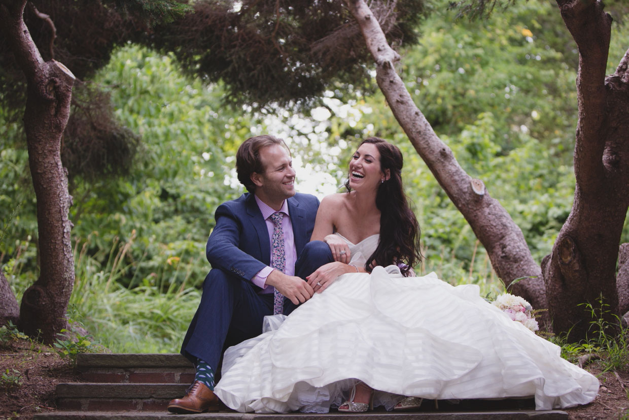 a couple laugh together during their backyard wedding in Massachusetts