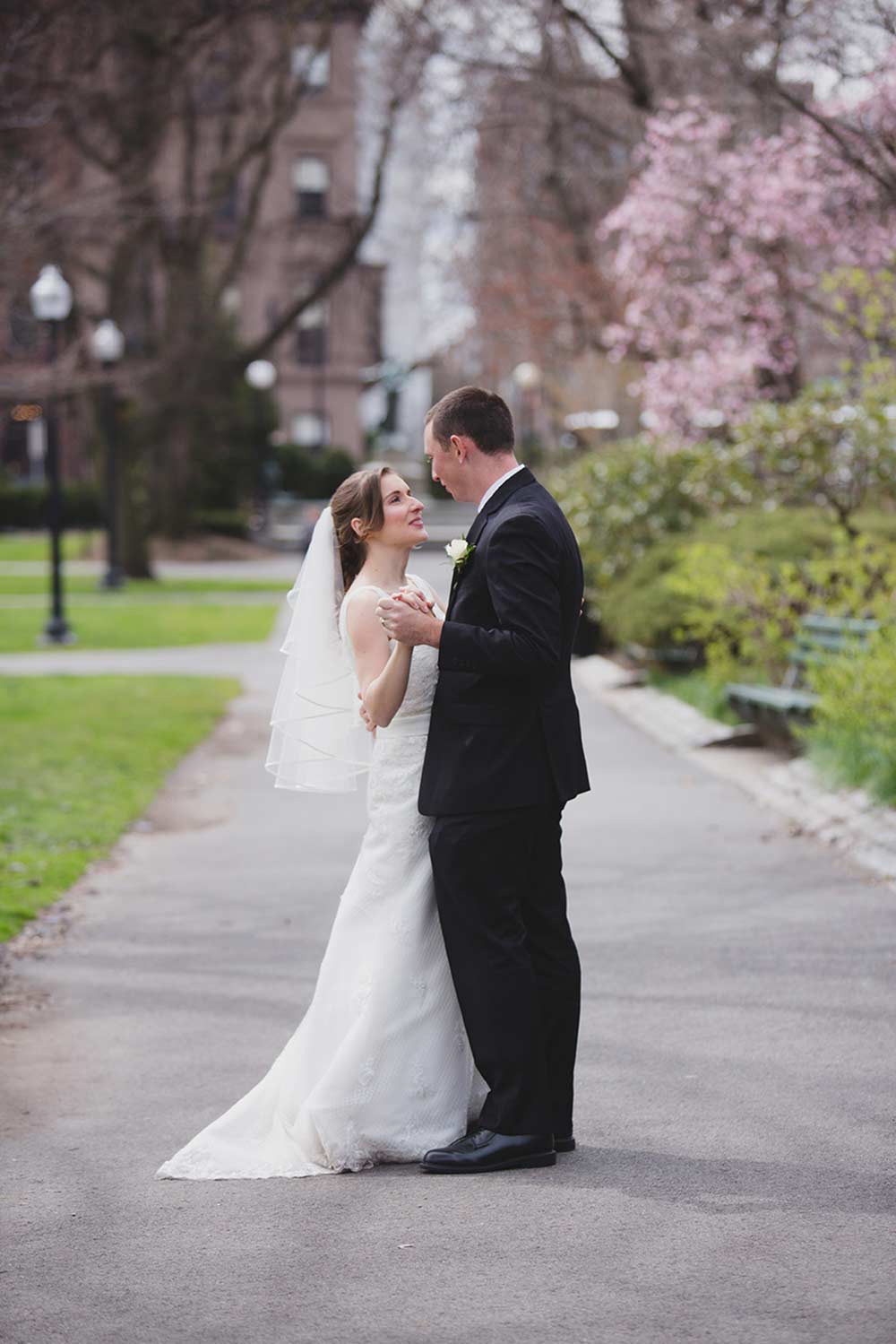A natural portrait of a couple dancing together during their wedding portraits in Boston Public Gardens