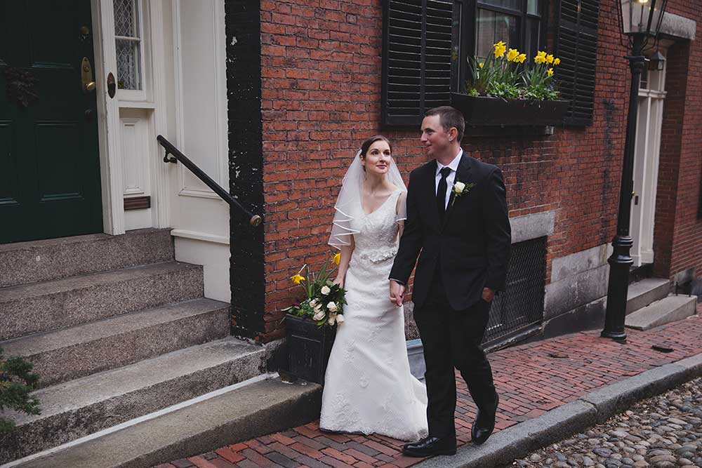 A documentary photograph of a couple walking through Beacon Hill during their wedding portrait session