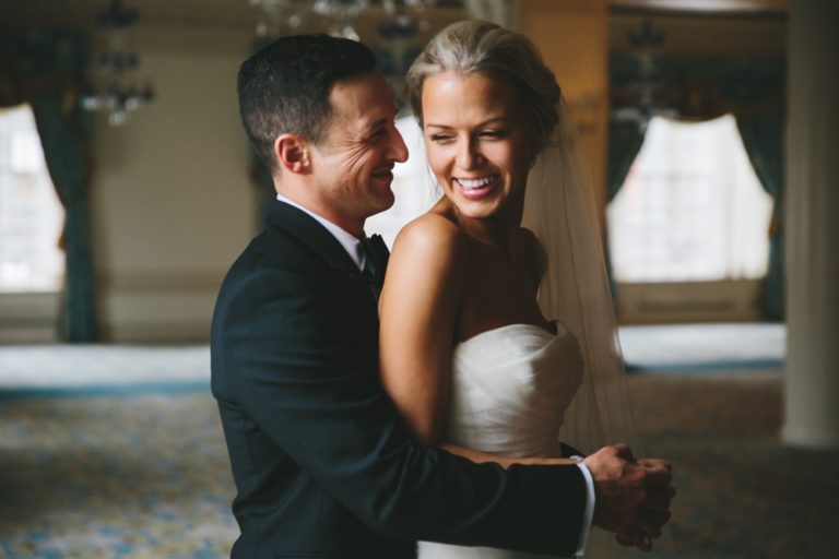 A documentary portrait of a bride and groom laughing together during their first look before their Taj Boston Hotel Wedding