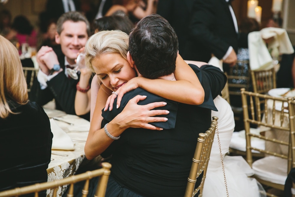 A documentary photograph of a bride hugging her friend during the reception of their Taj Boston Hotel Wedding in Massachusetts
