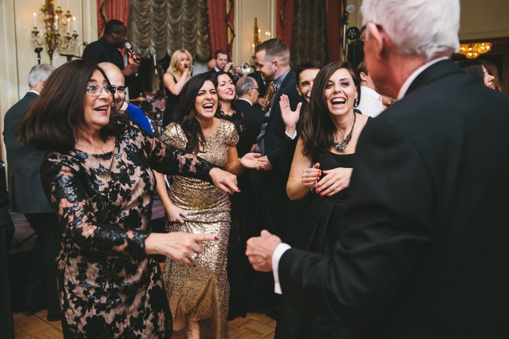 A documentary photograph of guests dancing and laughing during a Taj Boston Hotel Wedding in Massachusetts