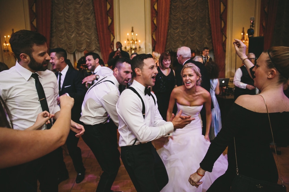 A documentary photograph of a bride and groom dancing with friends during their Taj Boston Hotel Wedding in Massachusetts