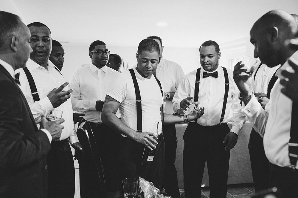 A documentary photograph of Groomsmen sharing a drink and toast before a Martha's Vineyard Wedding