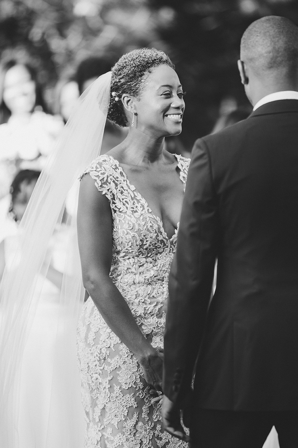 A documentary photograph of a bride smiling during her wedding ceremony on Martha's Vineyard