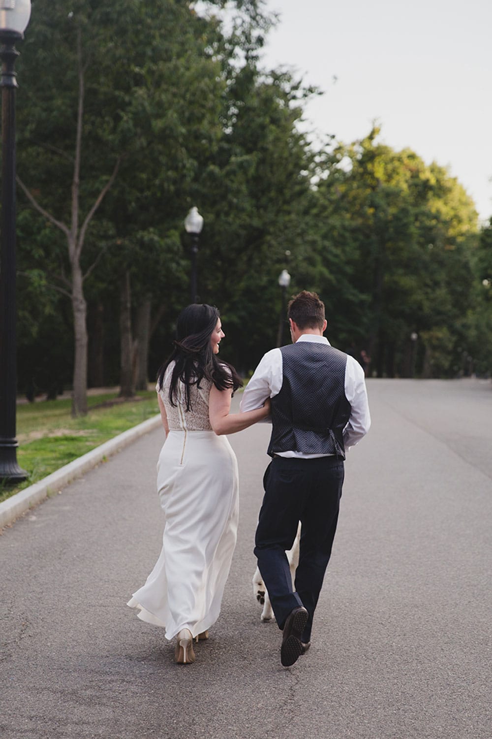 A documentary photograph of a couple walking through Boston Common during their Boston Engagement Session