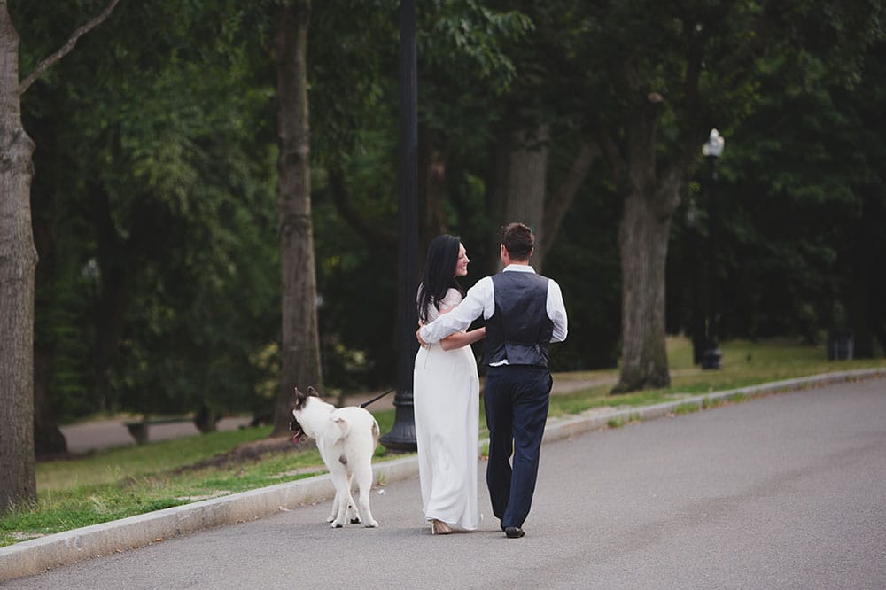 A documentary photograph of couple walking their dog through Boston Common during Boston Engagement Session