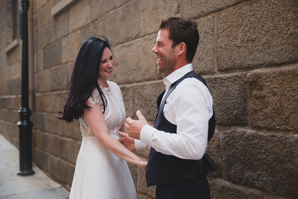 A documentary photograph of a couple laughing together during their Boston Engagement Session
