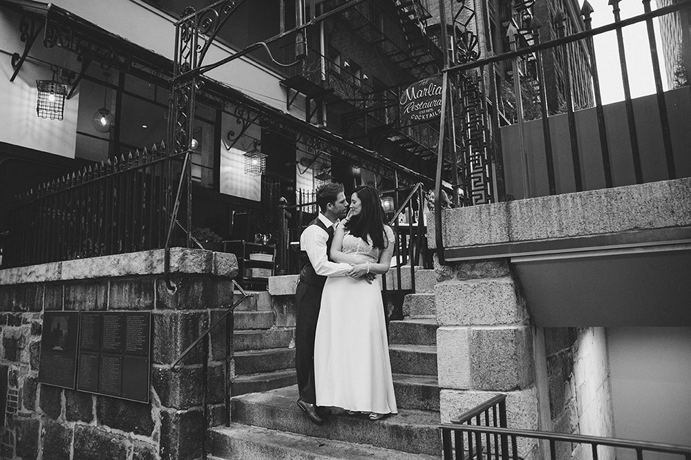 A relaxed portrait of a couple on the steps of Marliave Restaurant during their Boston Engagement Session